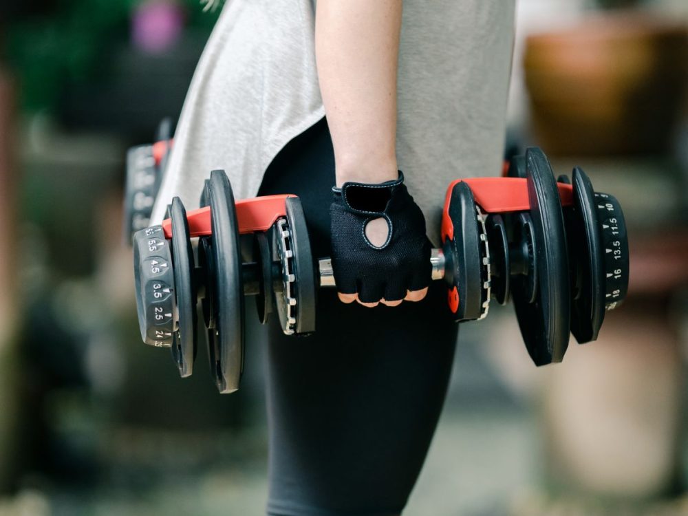 preparing for upper body exercises with adjustable dumbbells